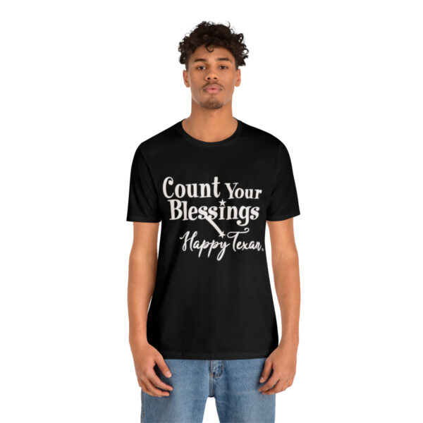 A man wearing a black t-shirt with the words " count your blessings happy tears ".