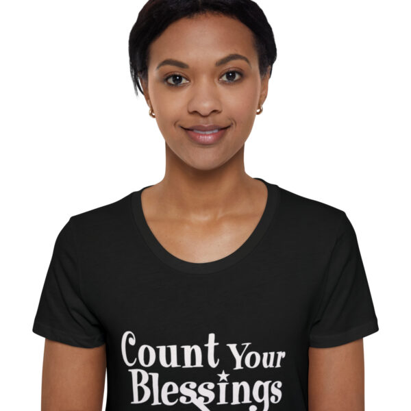 A woman wearing a black shirt with the words " count your blessings ".