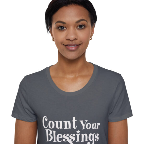 A woman wearing a t-shirt with the words " count your blessings ".