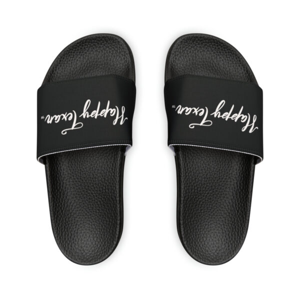 A pair of black slides with white lettering on them.