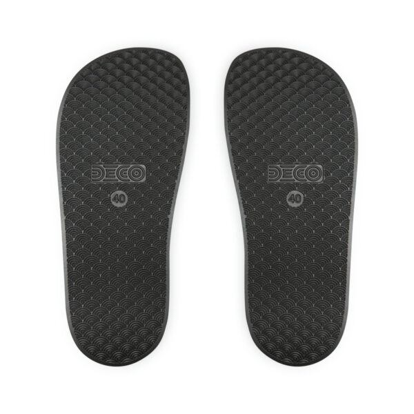 A pair of black flip flops with the word " surf " written on them.