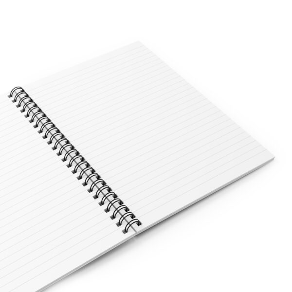 A spiral notebook with lined paper on top of it.