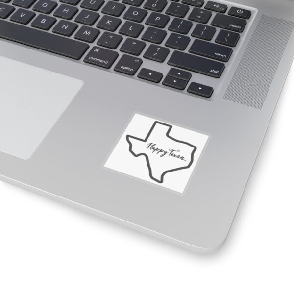 A laptop with a sticker of the state of texas.