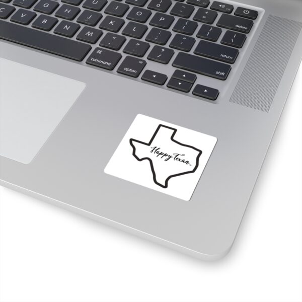 A laptop with a sticker of the state of texas.