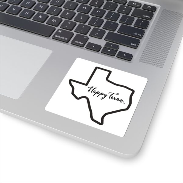 A laptop with a sticker of the state of texas.