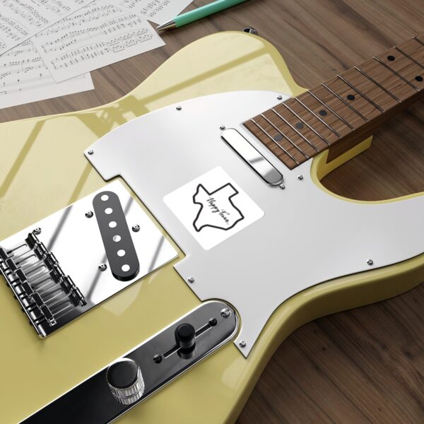 A yellow guitar sitting on top of a wooden table.