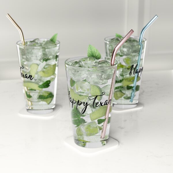 Three glasses of green drinks with a straw.