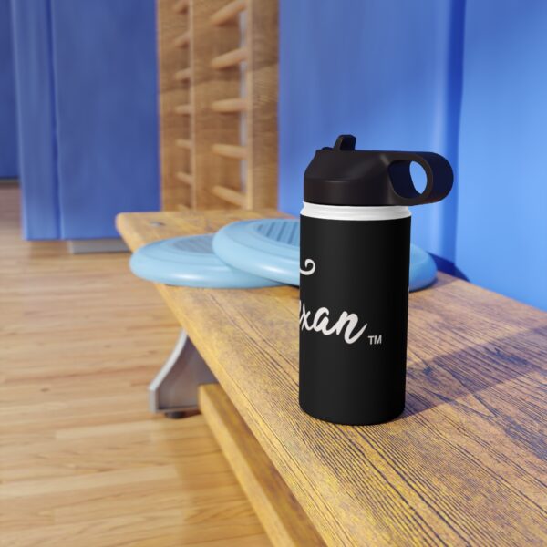 A black water bottle sitting on top of a wooden bench.