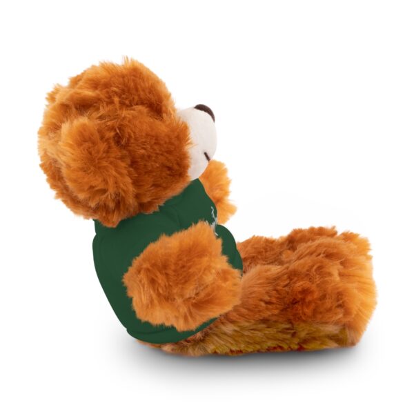 A stuffed bear sitting in a chair with its back turned.