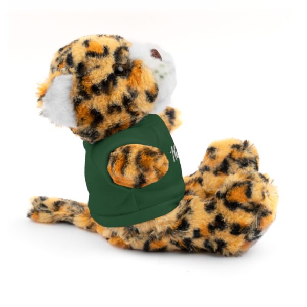 A stuffed animal with a green pacifier in its mouth.