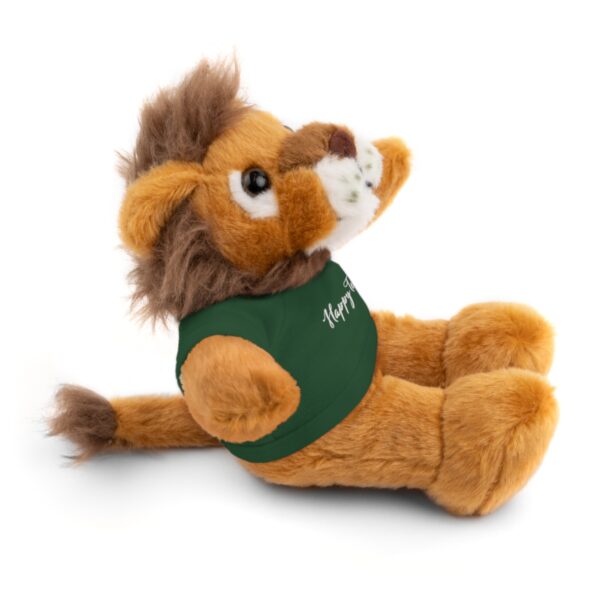 A stuffed lion with a green shirt on it's back.