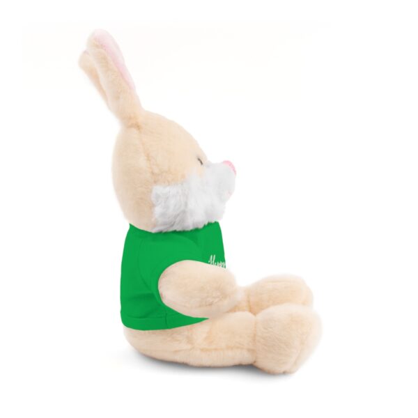 A stuffed bunny rabbit with a green shirt.