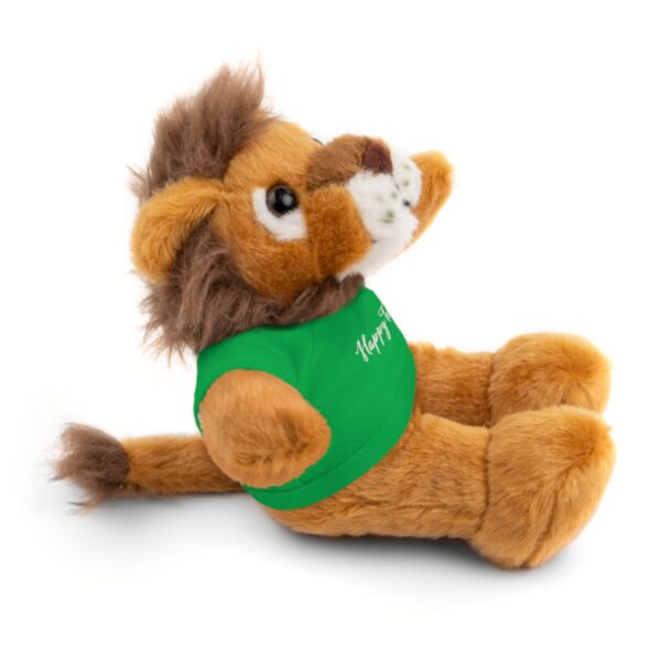 A stuffed lion with a green shirt on it's back.