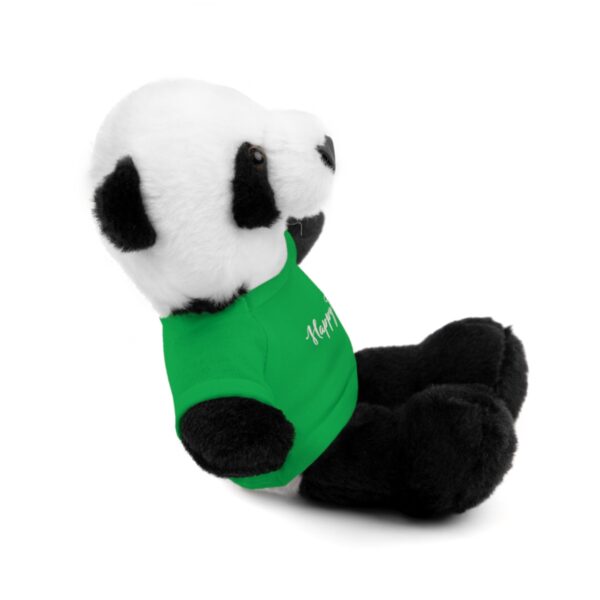 A stuffed panda bear with a green shirt.