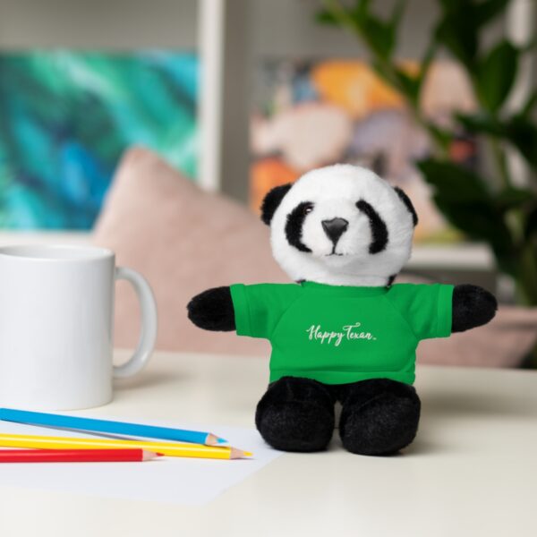 A stuffed panda bear sitting on top of a table.