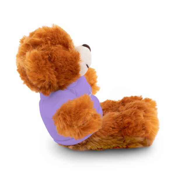 A teddy bear sitting in a chair with its back turned.