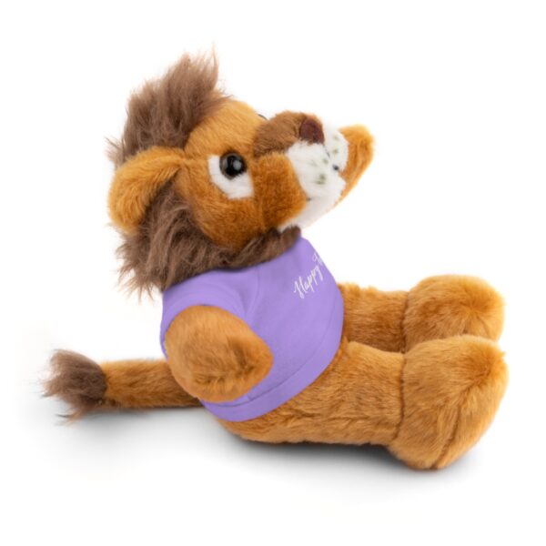 A stuffed lion with a purple shirt on