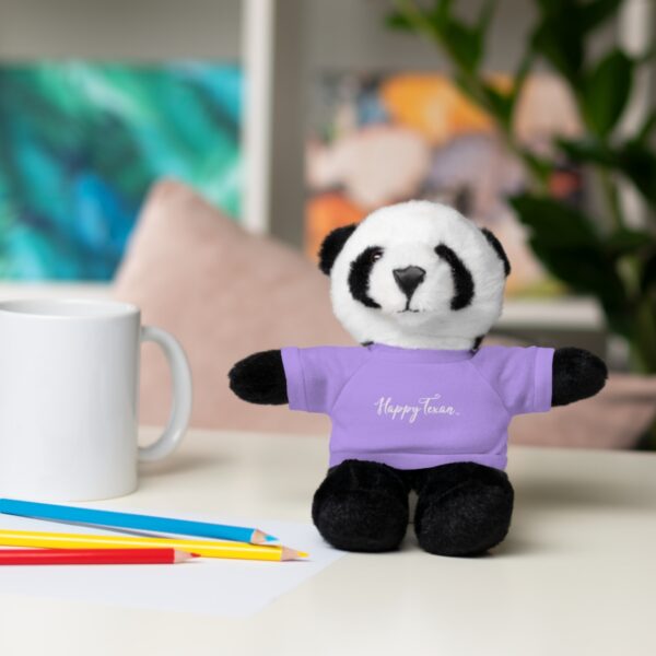 A stuffed panda bear sitting on top of a table.