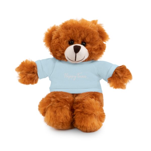 A brown teddy bear wearing a blue shirt.