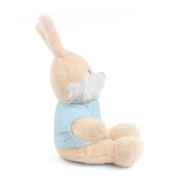 A stuffed bunny rabbit wearing a blue shirt.