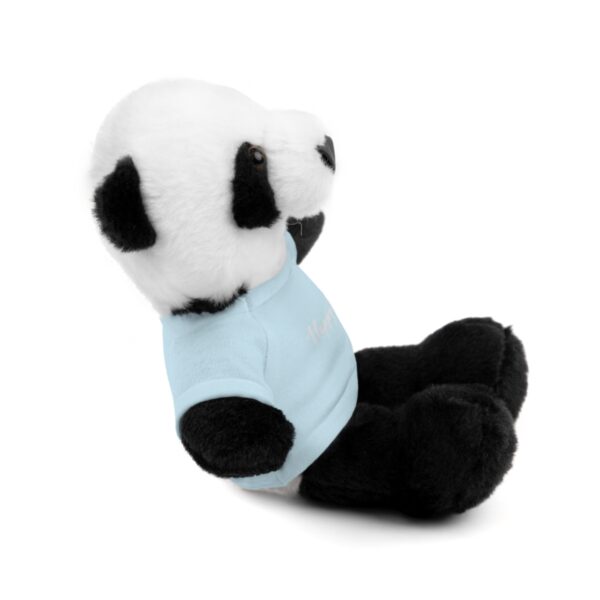 A stuffed panda bear with a blue shirt.