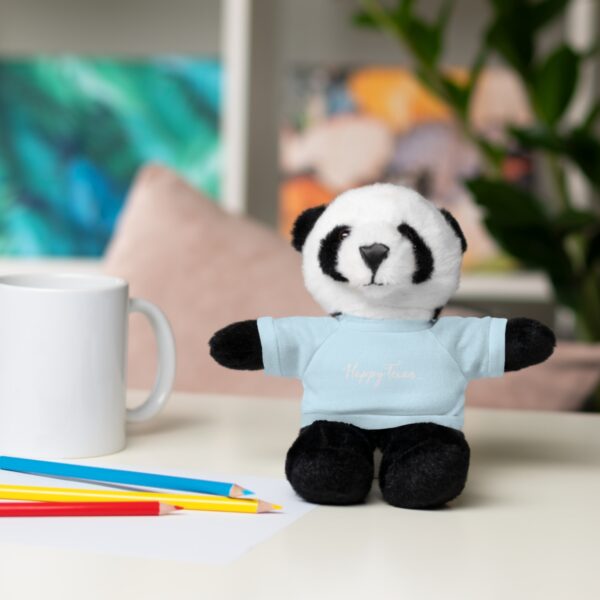 A stuffed panda bear sitting on top of a table.