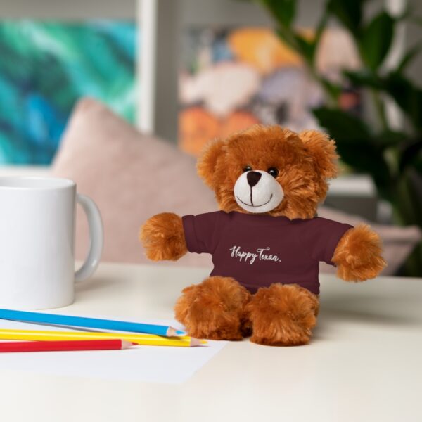 A brown teddy bear sitting on top of a table.