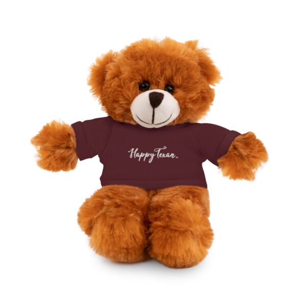 A brown teddy bear wearing a t shirt