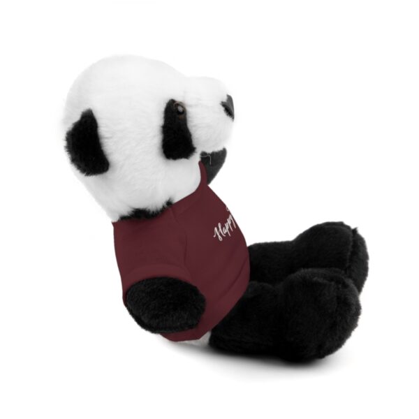 A stuffed panda bear sitting on top of the ground.