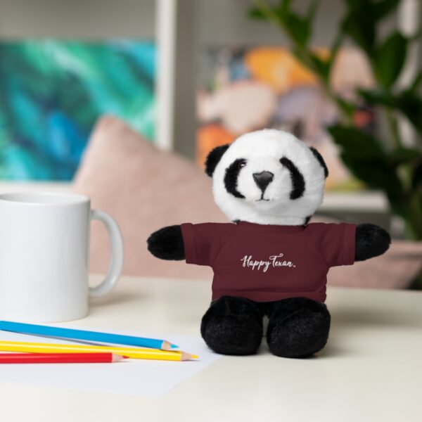 A stuffed panda bear sitting on top of a table.