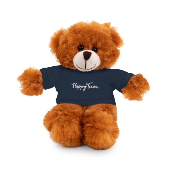 A brown teddy bear wearing a blue shirt.