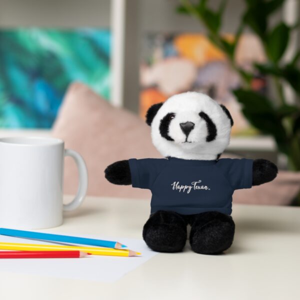 A stuffed panda bear sitting on top of a table.