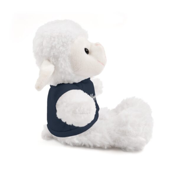 A stuffed animal is sitting down and wearing a shirt.