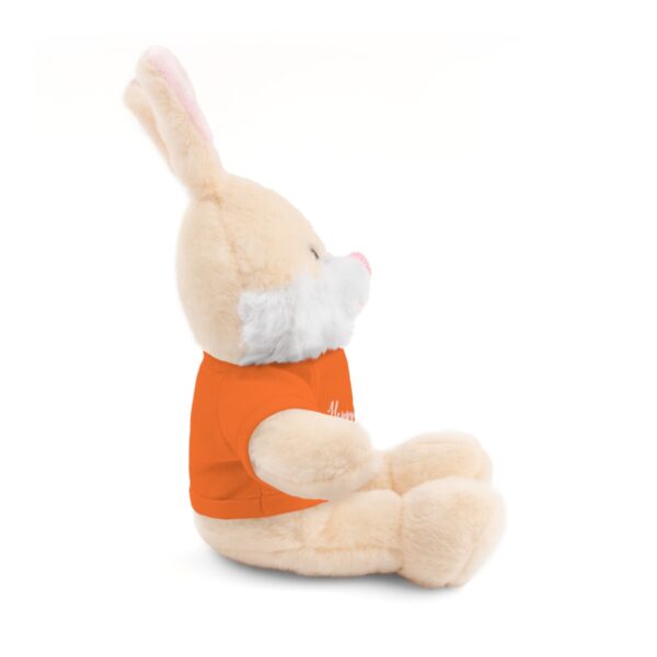 A stuffed bunny rabbit with an orange shirt.