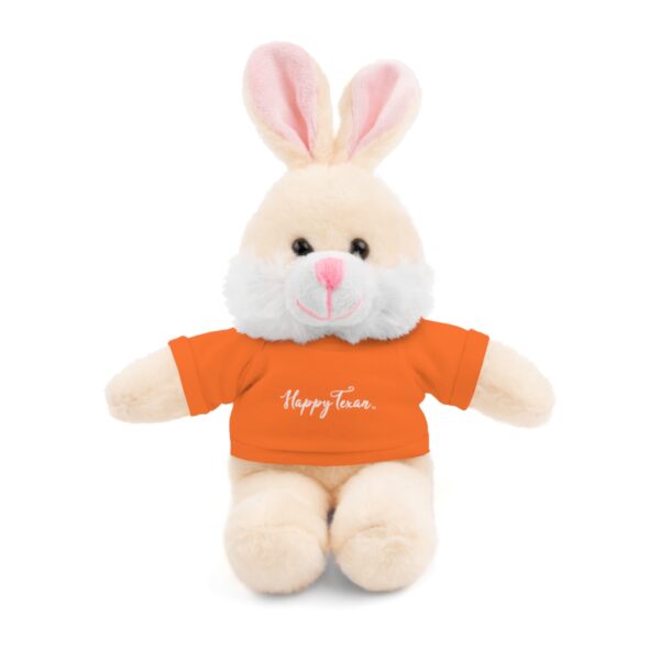 A stuffed bunny with an orange shirt on it's back.