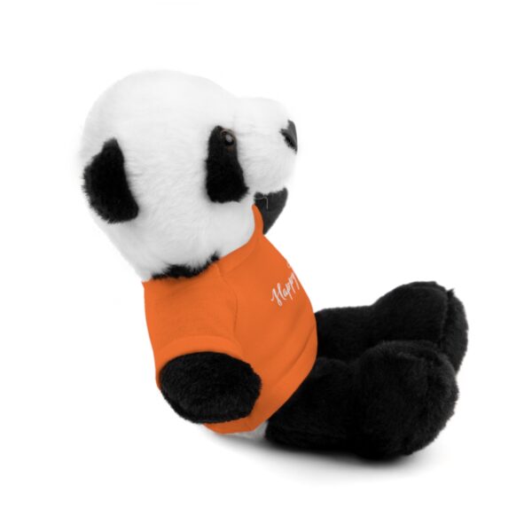 A stuffed panda bear sitting on top of the ground.