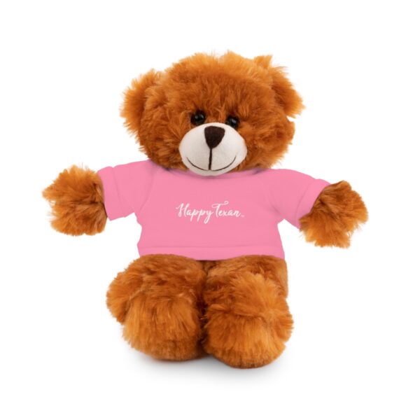 A brown teddy bear wearing a pink shirt.