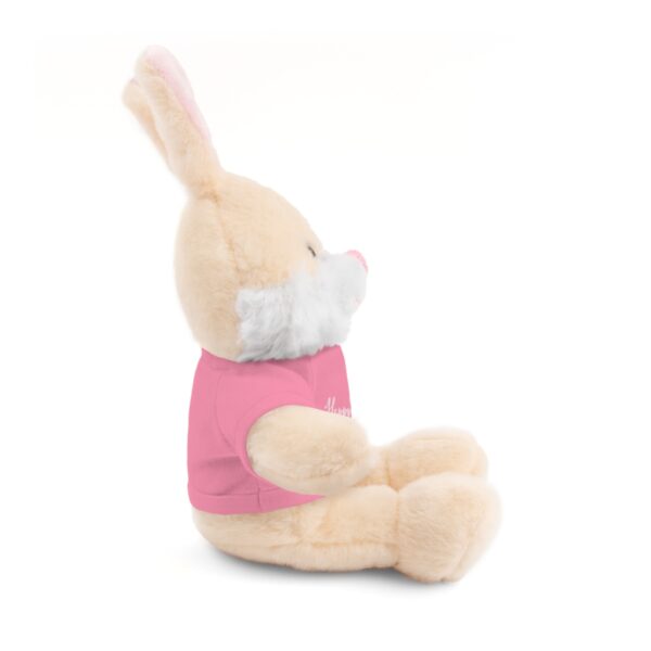 A stuffed bunny rabbit wearing a pink shirt.